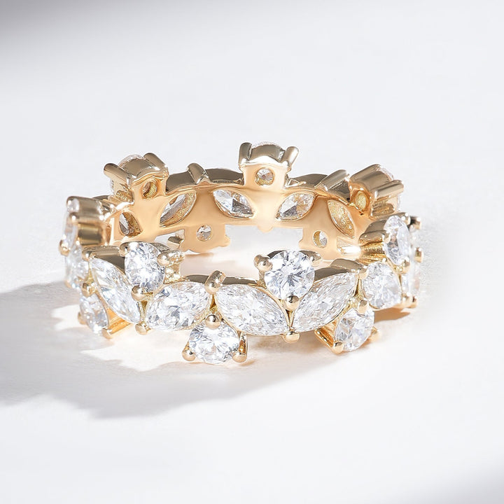 Angled view of 18K yellow gold eternity band with alternating marquise and round diamonds in a continuous full-circle design.