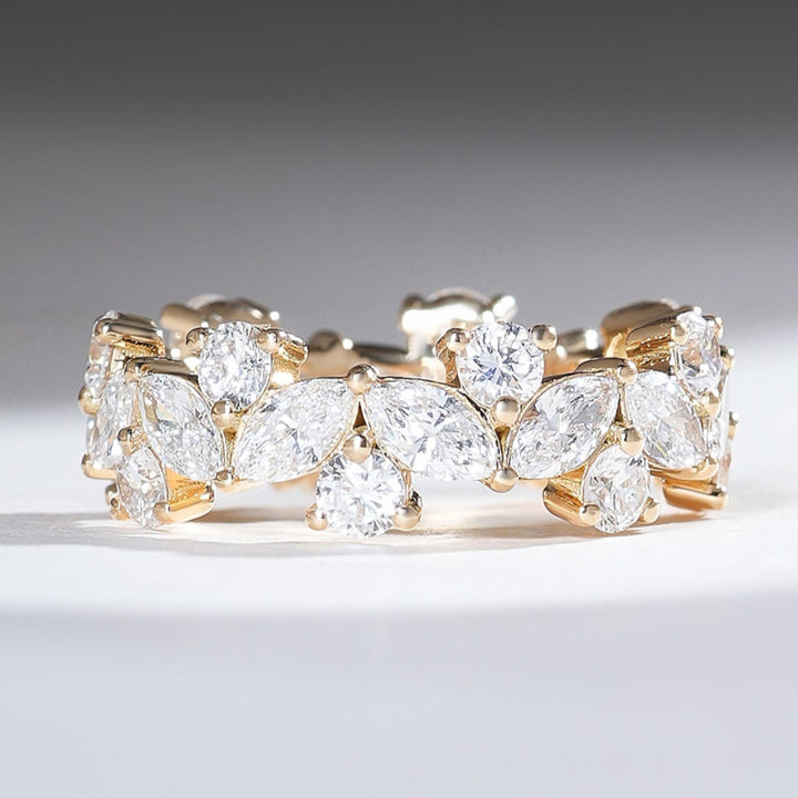 18K yellow gold eternity band featuring alternating marquise and round brilliant diamonds for a floral-inspired sparkle.