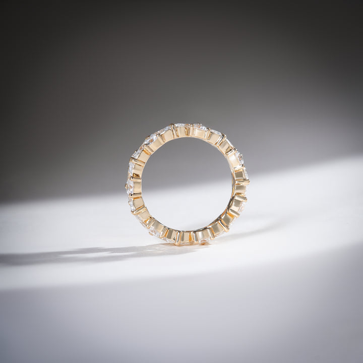 Top profile of yellow gold eternity band with alternating diamond cuts for a balanced and elegant look.