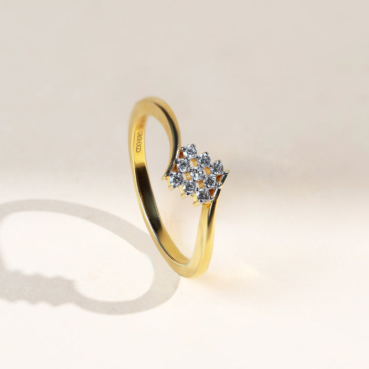 Angled view of the Nine Diamonds Ring showcasing its curved gold band and diamond cluster.