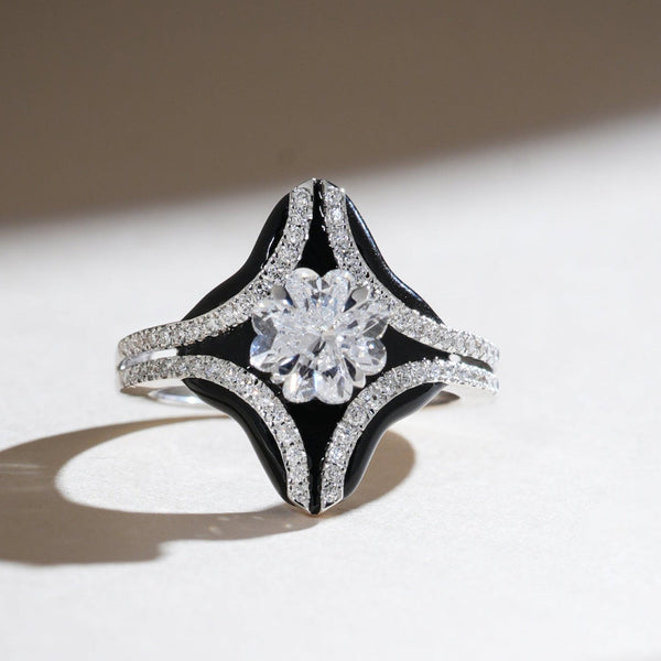 Onyx Bloom ring with a 1-carat Lilly cut diamond, framed by black onyx and pavé diamond accents in a star-shaped design.