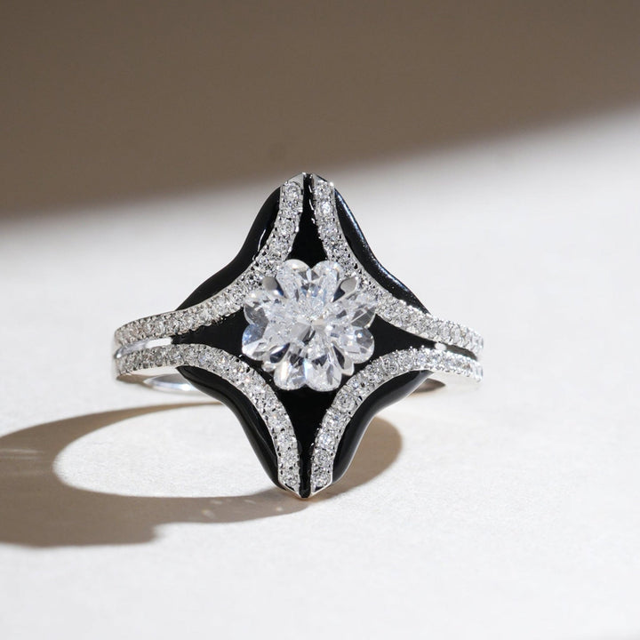 Onyx Bloom ring with a 1-carat Lilly cut diamond, framed by black onyx and pavé diamond accents in a star-shaped design.
