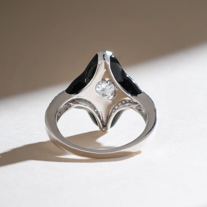 Underside of Onyx Bloom ring revealing hidden bezel-set diamond and polished metal gallery