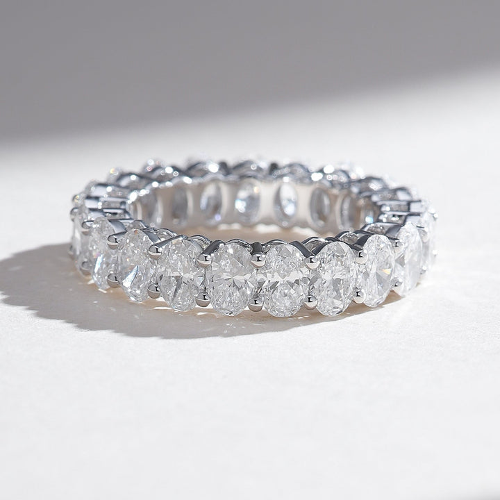 White gold eternity band featuring a continuous row of oval-cut diamonds for maximum brilliance.