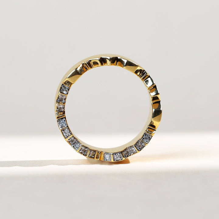 Back view of couple ring in yellow gold with diamonds set along zig-zag cut pattern.