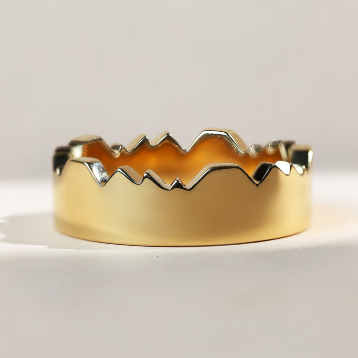 Side profile of gold couple band with sculpted inner design.
