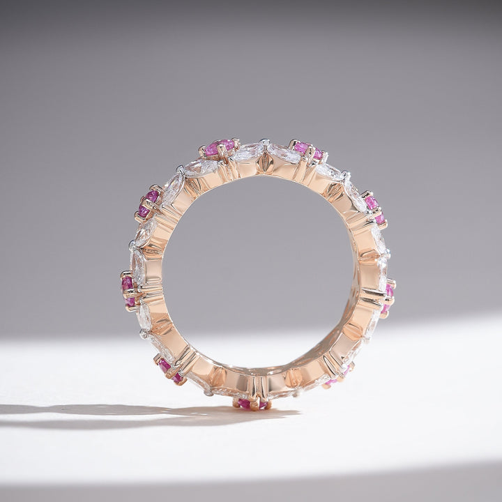 Side profile of the Pink Dahlia Eternity Band revealing the symmetrical gemstone placement and polished rose gold band.
