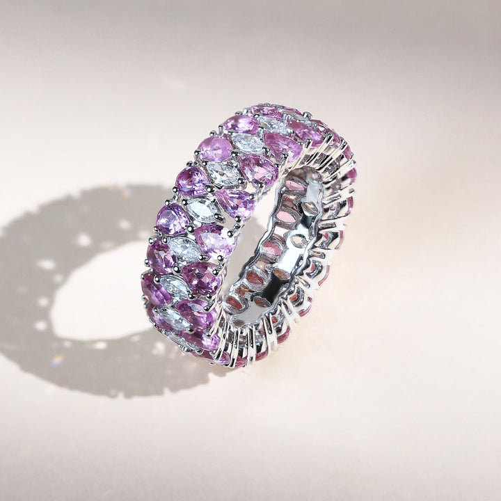 Angled view of Pink Pear and Marquise Eternity Band featuring vivid pink gemstones and diamonds