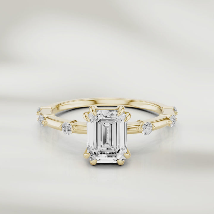 360-degree view of the Solstice Radiant Band in 18K champagne gold, featuring an emerald-cut diamond center and evenly spaced round diamond accents, shown in full rotation to highlight every detail