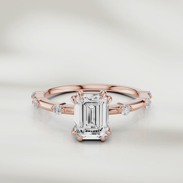 360-degree view of the Solstice Radiant Band in 18K rose gold, featuring an emerald-cut diamond center and evenly spaced round diamond accents, shown in full rotation to highlight every detail
