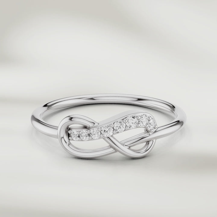 360-degree video of infinity knot diamond ring in gold with pavé-set accents and slim polished band