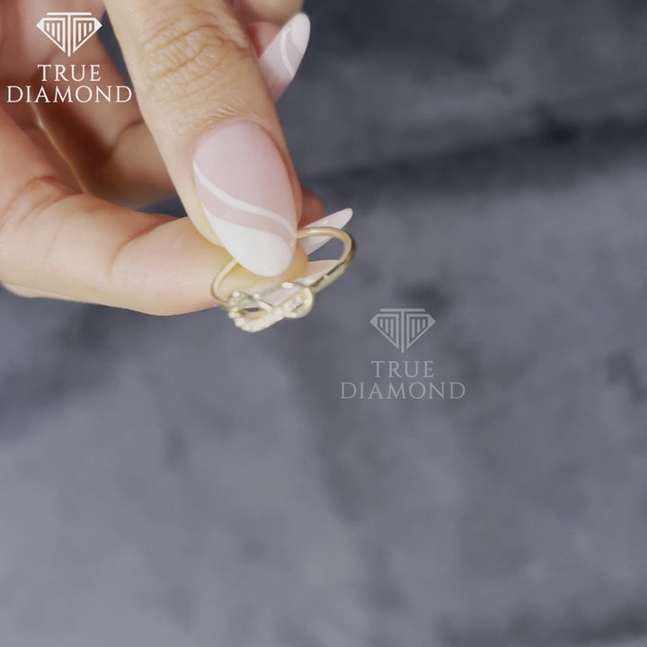 Video of woman wearing infinity knot diamond ring in gold with pavé-set accents and slim polished band
