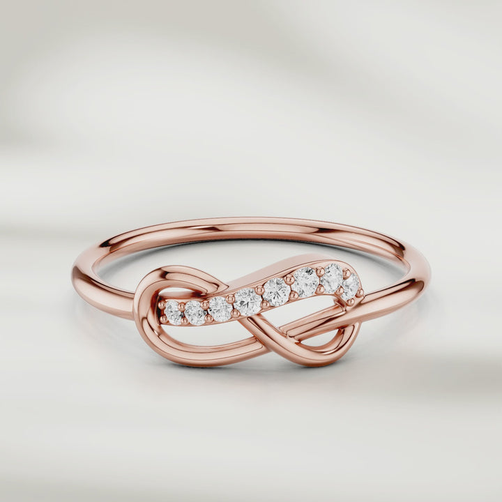 360-degree video of infinity knot diamond ring in gold with pavé-set accents and slim polished band