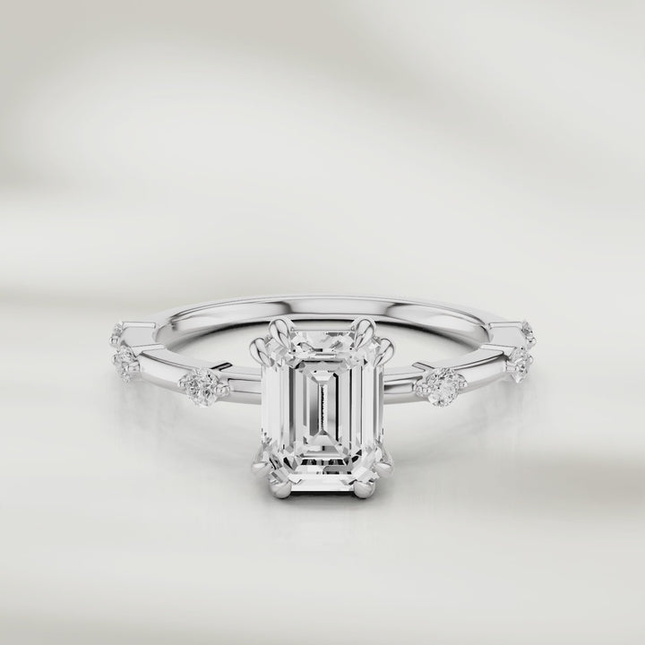 360-degree view of the Solstice Radiant Band in 18K rose gold, featuring an emerald-cut diamond center and evenly spaced round diamond accents, shown in full rotation to highlight every detail