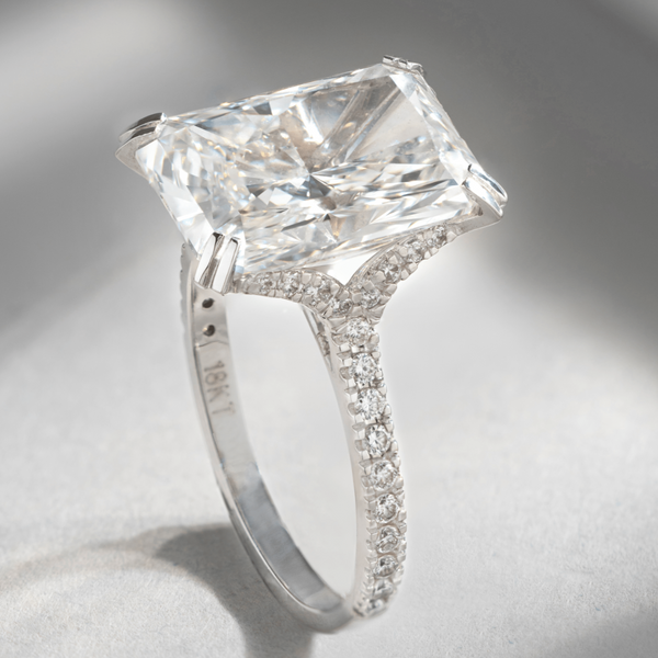 6-carat radiant cut diamond solitaire ring in 18K white gold with pavé-set band, angled view
