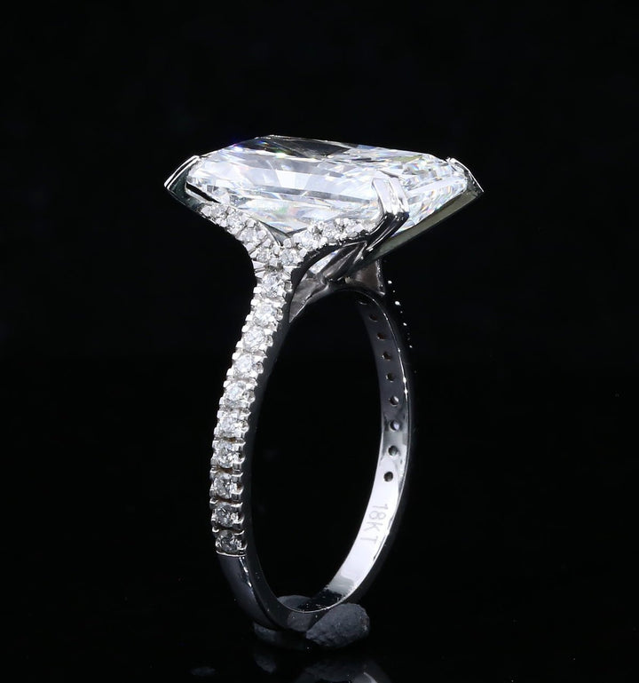 Side profile of 6-carat radiant cut solitaire ring showing pavé-set diamond shank and elevated claw-prong setting