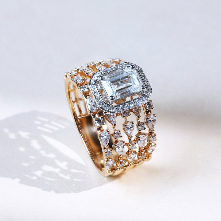 Angled view of Raindrop yellow gold ring with emerald-cut halo solitaire and pavé-set raindrop pattern