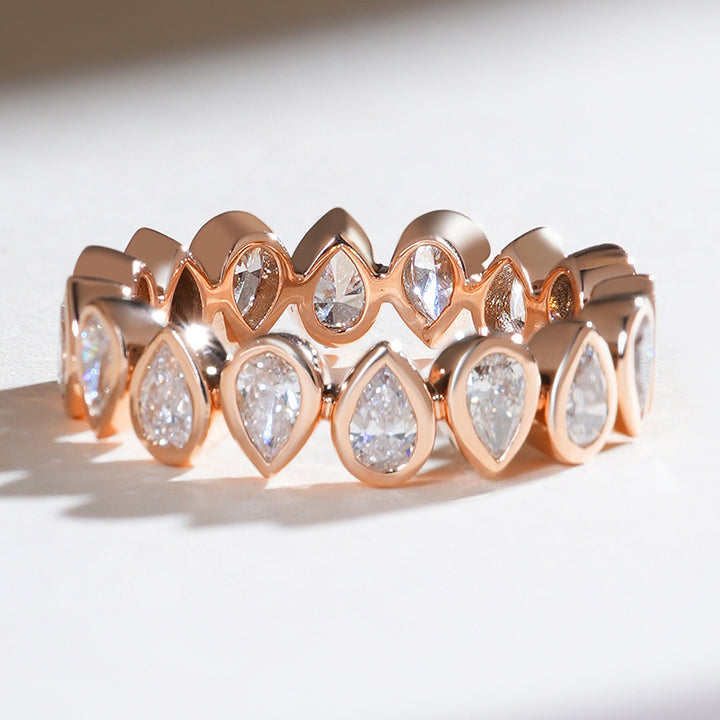 Angled shot of the reverse pear eternity band highlighting the unique alternating diamond orientation.
