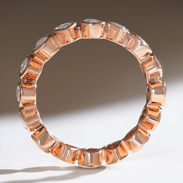 Side profile of the reverse pear eternity band with sleek, polished rose gold edges