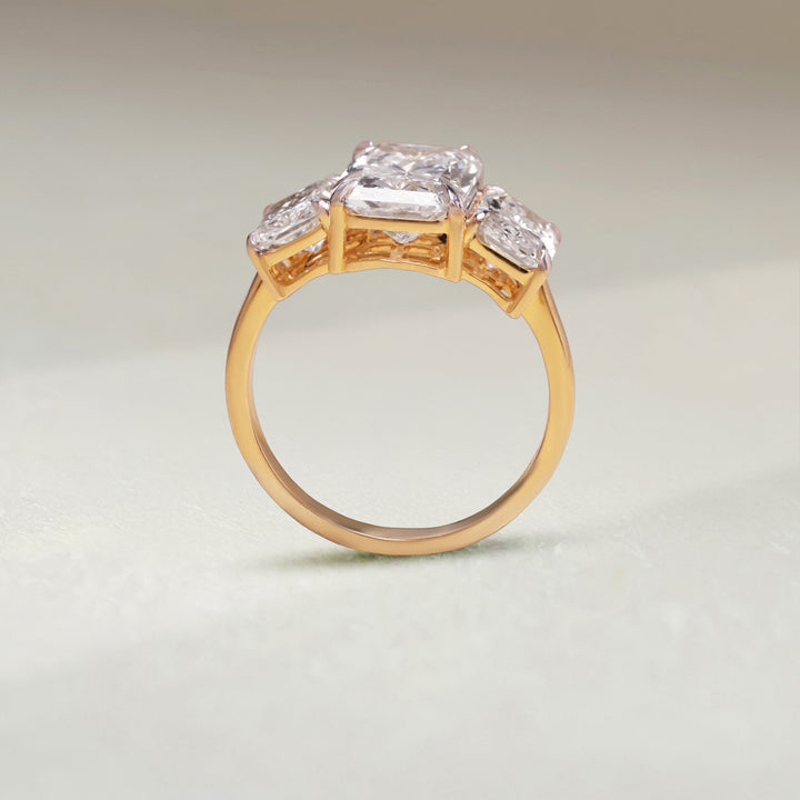 Upright view of Triple Radiance 5 Ct Three Stone Ring in yellow gold with three radiant-cut diamonds.
