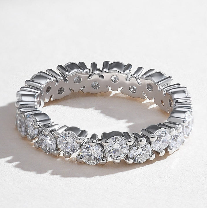 Angled view of white gold eternity band featuring perfectly matched round brilliant diamonds.