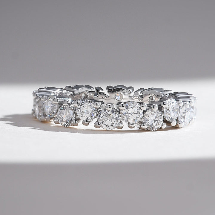 White gold eternity band with a continuous row of round brilliant diamonds for timeless sparkle.