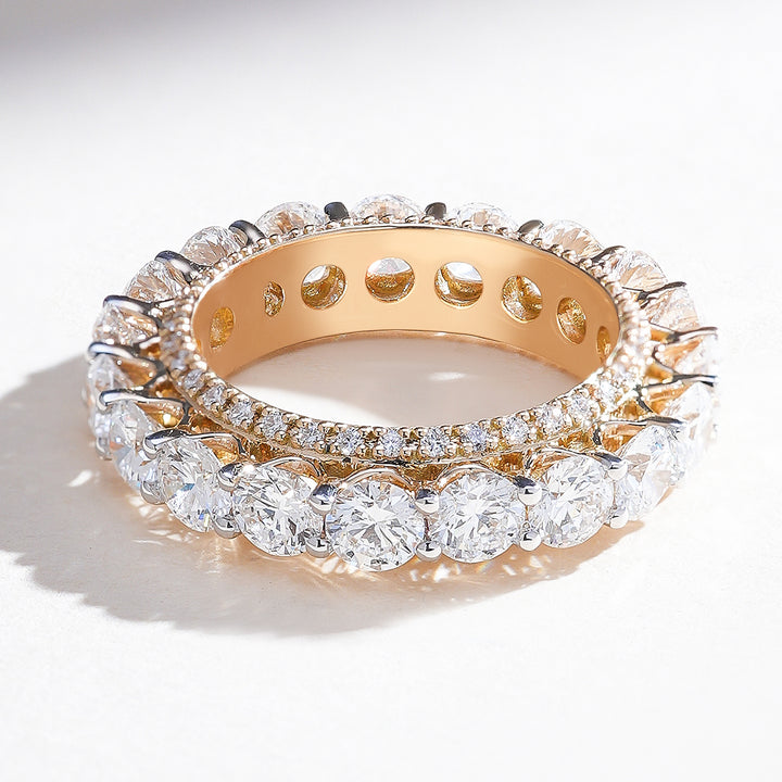 Angled top view of yellow gold 4.5 Ct eternity band with round brilliant diamonds in a secure prong setting.