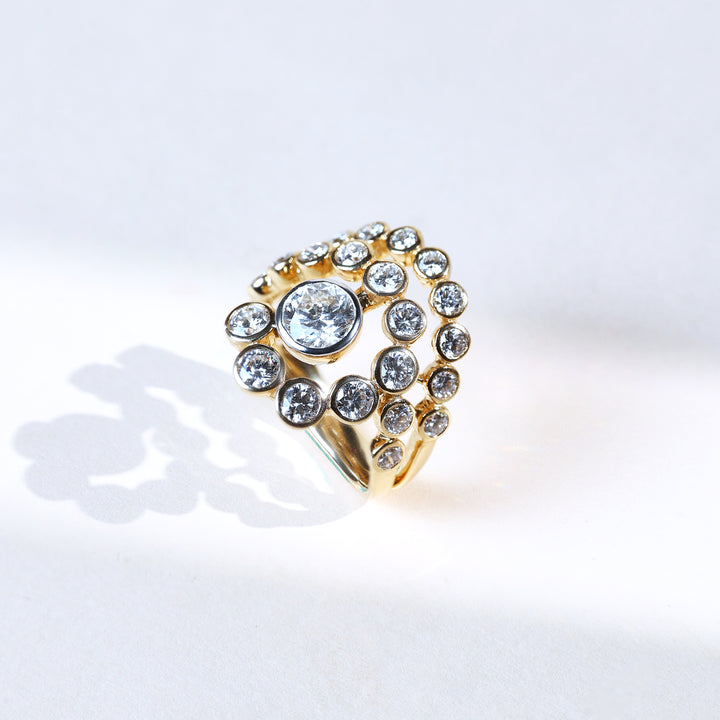 Yellow gold round ray diamond cocktail ring with radiating bezel-set diamonds
