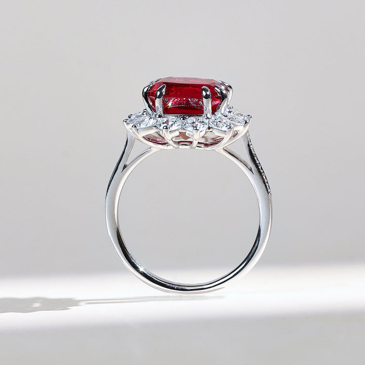 Side profile of Ruby Embrace ring with cushion-cut ruby and diamond halo in white gold