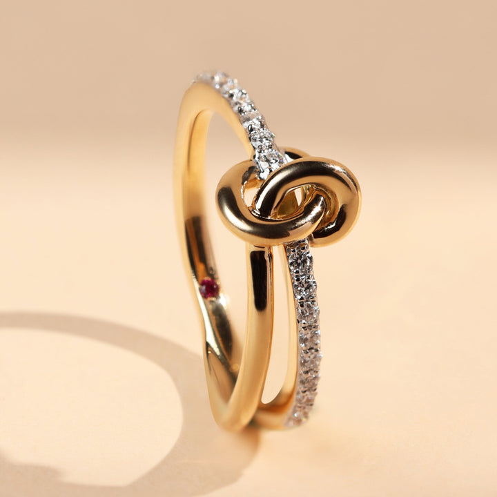 Angled view of Sacred Knots Promise Ring featuring interlocked knot and sparkling diamond accents.