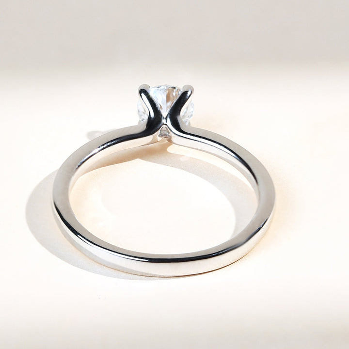 Sleek white gold solitaire ring with claw prong setting, back profile