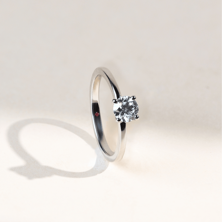 Classic white gold solitaire ring featuring a 0.5 Ct round diamond, side angle