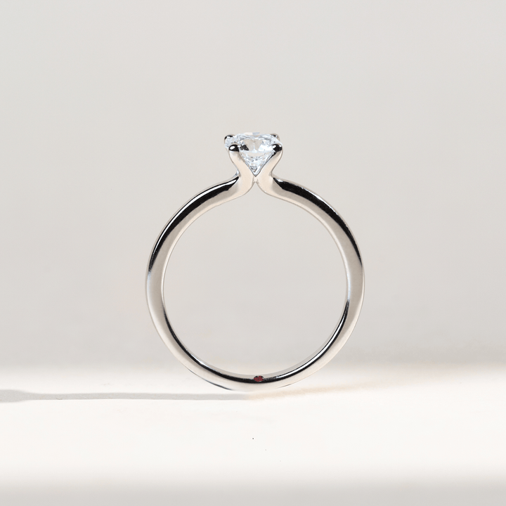 White gold solitaire ring with a 0.5 Ct diamond in a raised four-prong setting, top view