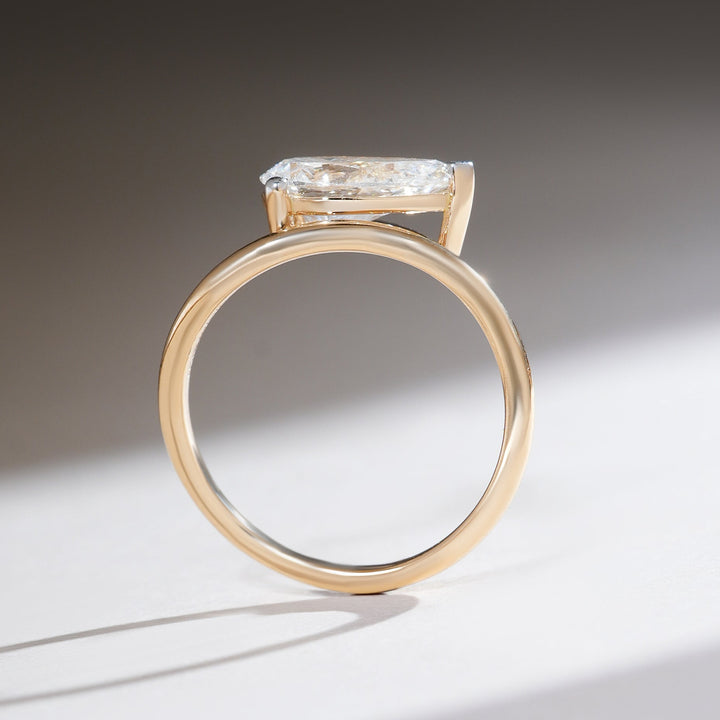 Profile view of the Sirena 1.7 Ct pear solitaire ring showcasing the slim gold band and elevated diamond setting.