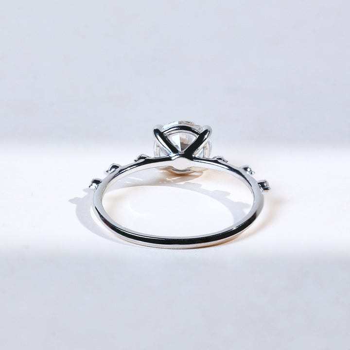 Back view with solitaire setting and thin white gold band.