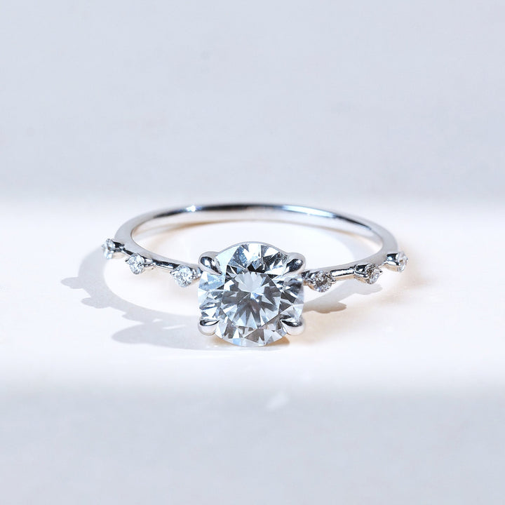 Front view of Solstice 1 Ct round solitaire ring with scattered diamond band.