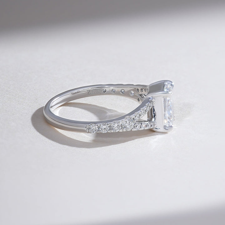 Side profile of split shank pave 1 carat radiant solitaire ring showing diamond-accented band.