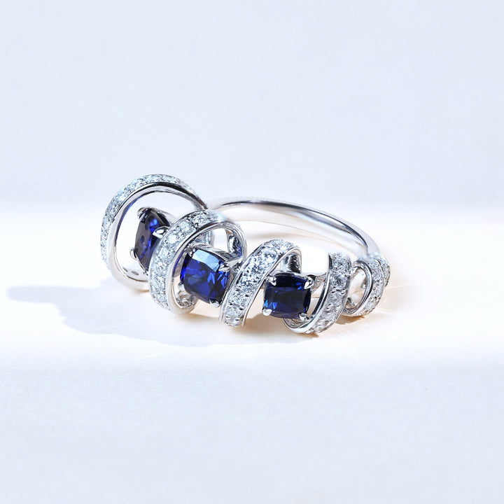 Close-up of Star Weave Cocktail Ring with sapphire center and diamond spiral design