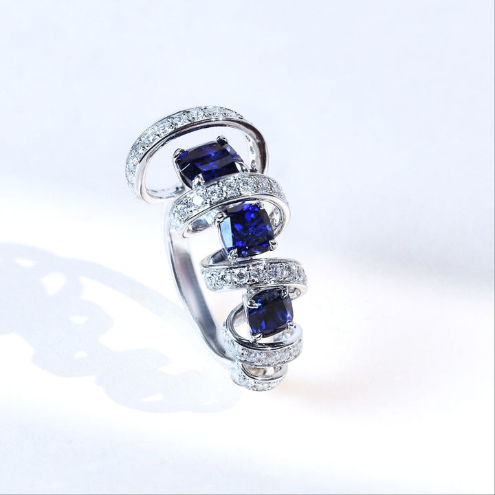 Angled view of sapphire and diamond Star Weave Cocktail Ring showcasing spiral band