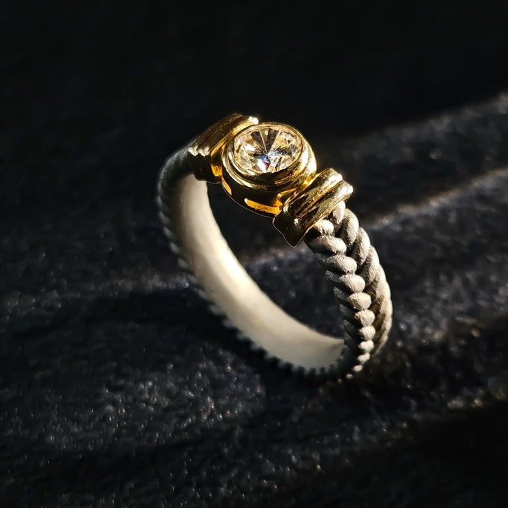Front angle of Stonecrest Titanium Ring with rope-pattern band and gold bezel-set solitaire.