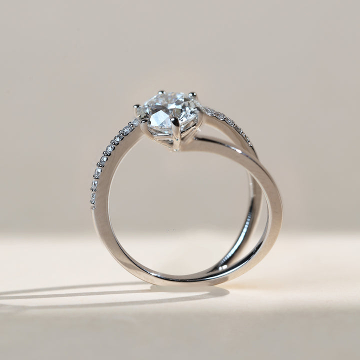 Side profile of the six-prong setting and slender bypass shank with pavé detail.