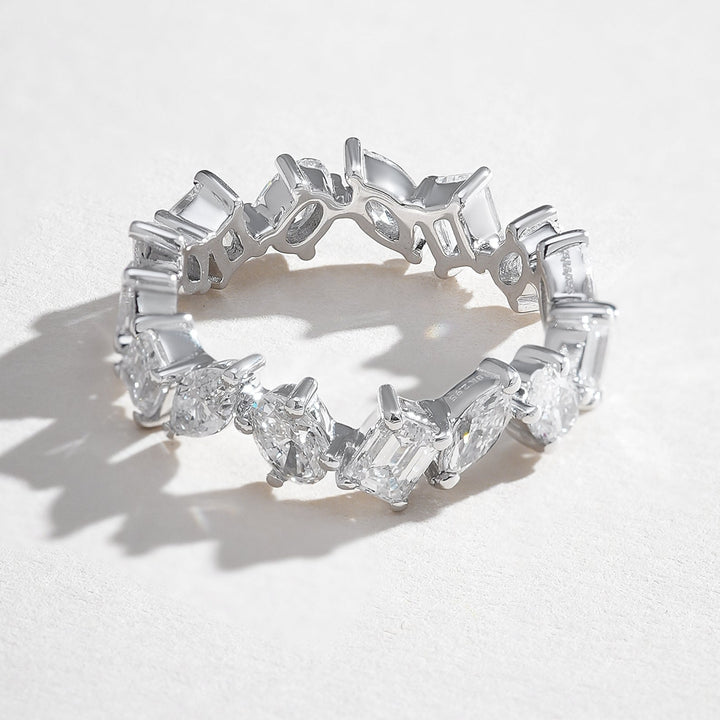 Angled side view highlighting the prong-set marquise, oval, and emerald-cut diamonds in the Trio Forever 2 Ct Eternity Band.