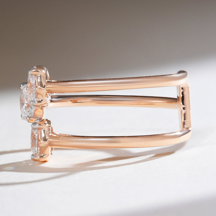 Side profile of triple solitaire diamond ring showing split shank design in polished rose gold