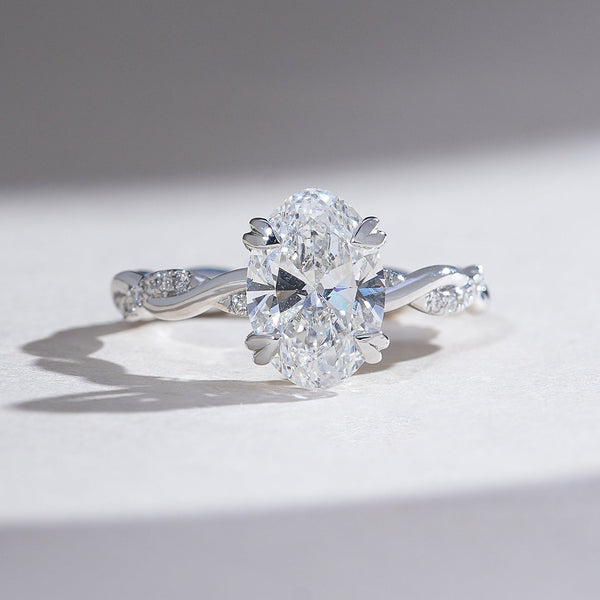 Oval Diamond Solitaire ring in Heart prong setting and a diamond encrusted twisted band in white gold