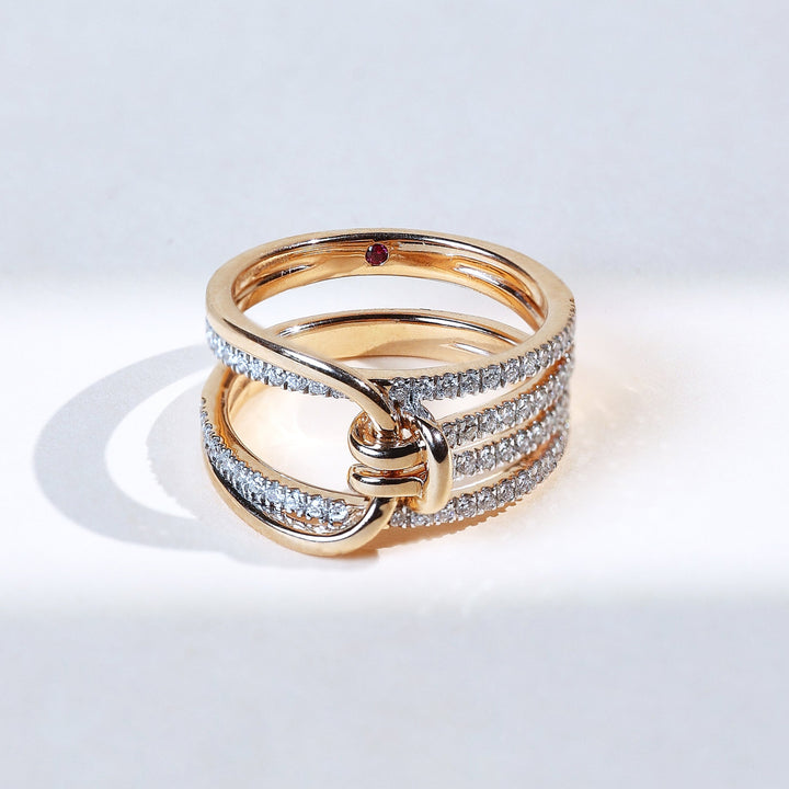 Close-up of Twisted Knot Promise Ring with diamond-studded loops in yellow gold.