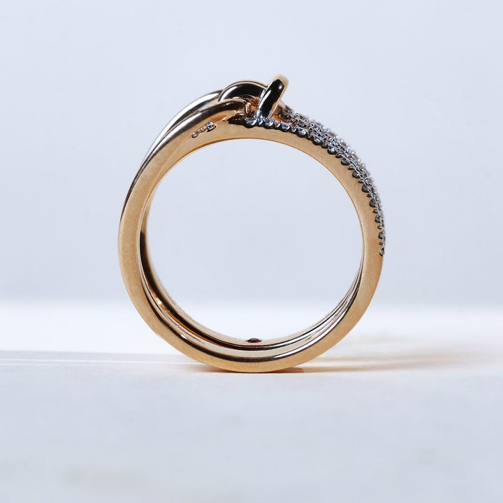 Top angle of Twisted Knot Promise Ring with pavé diamonds across multiple bands.