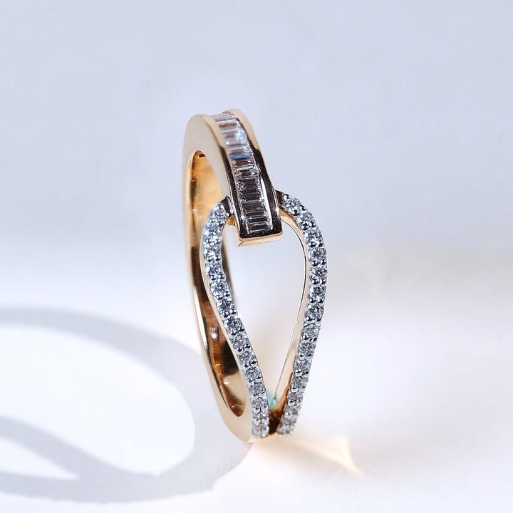 Angled view highlighting the heart-shaped knot design with baguette and round diamonds.