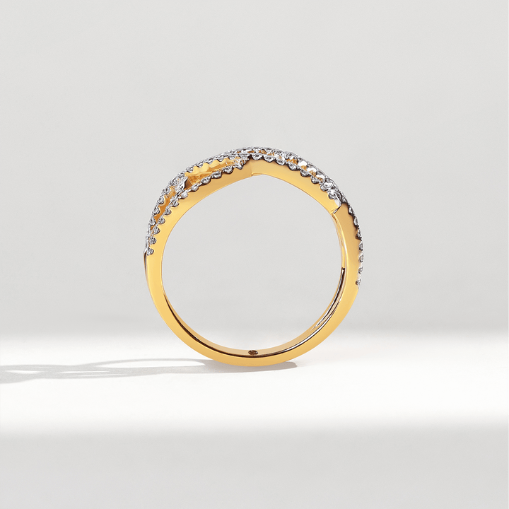 Profile angle of Weaved In Dailywear Ring displaying curved gold band with pavé diamonds.