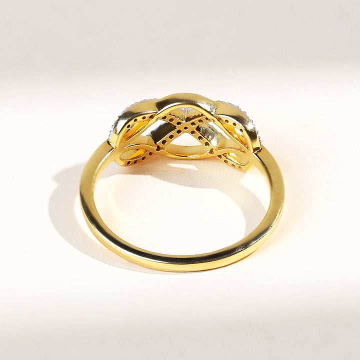 Back view of Woven to Infinity ring in polished 18K yellow gold with delicate diamond detailing on the intertwined design.